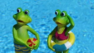 two-green-frog-near-body-of-water-figurines